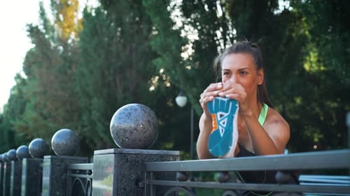 Closeup active woman exercising and stretching in city park