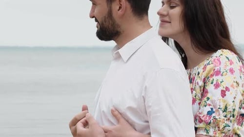 Loving Couple Embrace on a Beach Together