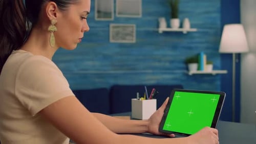 Woman Working at Office Desk Using Mock Up Green Screen Tablet Computer