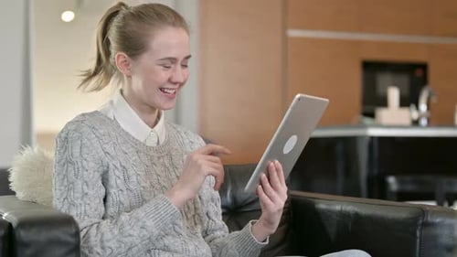 Woman Video Chatting on a Tablet at Home