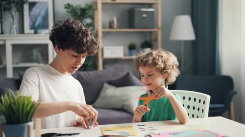 Creative Girl and Her Smart Kid Making Paper Collage Creating Design