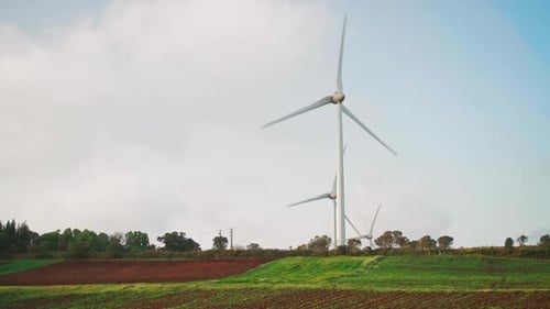 Wind Turbines in Farm Field on Cloudy Day