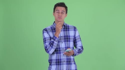 Man Thinking and Smiling While Using Phone