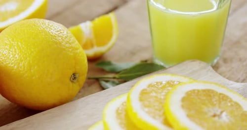 Close-up of sweet limes with glasses of juice