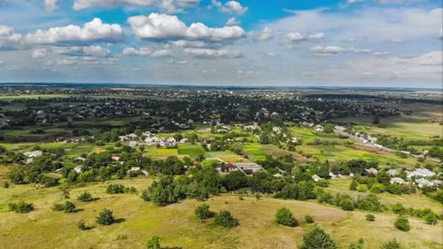 Hyperlapse of Village and Small Houses with Moving Clouds in Sky From a Flying Drone