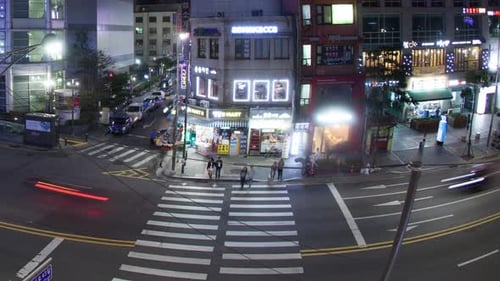 Timelapse of cars and pedestrians traffic on night road in Seoul, South Korea