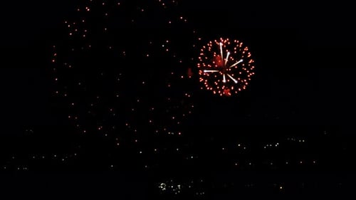Vibrant Fireworks Display Over City at Night