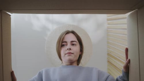Unhappy Woman Opening a Box from the Inside