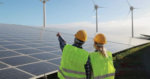 Young working people at renewable energy farm