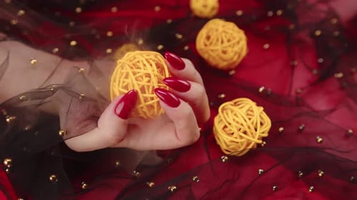 Hand Holding Decorative Ball on Sparkly Background