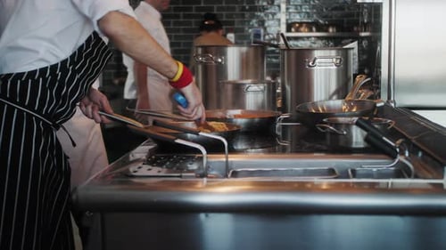 Chefs Cooking Food in Commercial Kitchen
