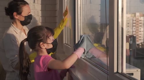 Mother and Daughter Cleaning Windows Together