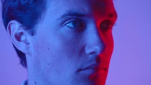 Man Close Up Illuminated in Red and Blue Light