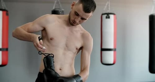 Fighter Puts on the Gloves in Slow Motion Boxer in the Gym Gets Ready to Train Prores HQ 60 Fps