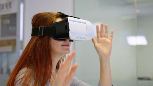 Businesswoman using virtual reality headset in a modern office 4k