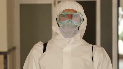 Masked Medical Professional Looks into the Camera