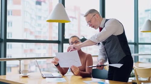 Business Team Discussing Data in Modern Office
