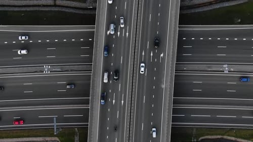 Aerial View of a Twolevel Road Intersection with Moving Cars