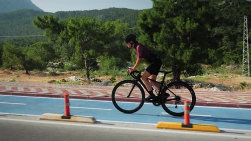 Cycling intense workout. Professional female cyclist riding bicycle