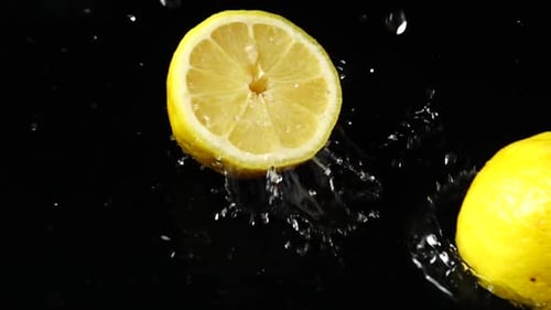 Lemons Splashing in Water on Black Background