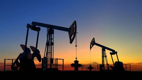Oil Pumpjacks Silhouetted at Sunset for Energy Production
