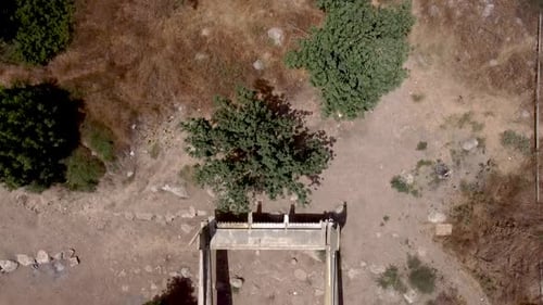 aerial Birdseye view backwards slowing drone shot of an old dismantled army plane monument placed on