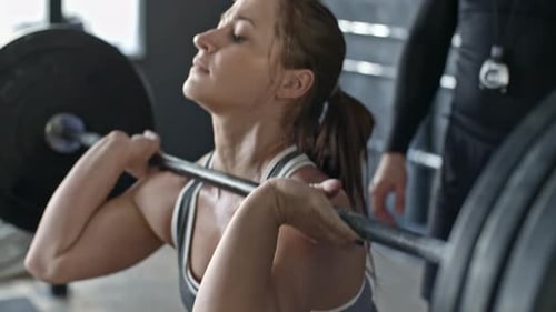 Fit Woman Lifting Weights at Gym