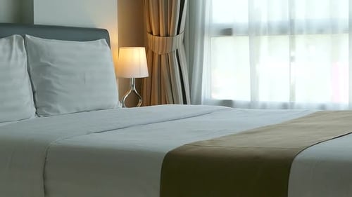 Modern Bedroom Interior with White Linens and Lamp