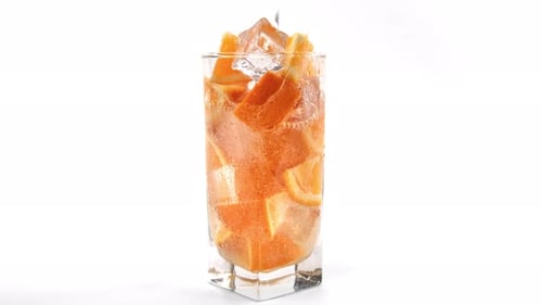 Refreshing Orange Drink with Ice Cubes in Glass