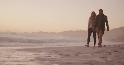 Active senior couple walking on beach