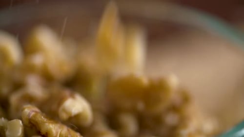 Walnuts Falling into Bowl