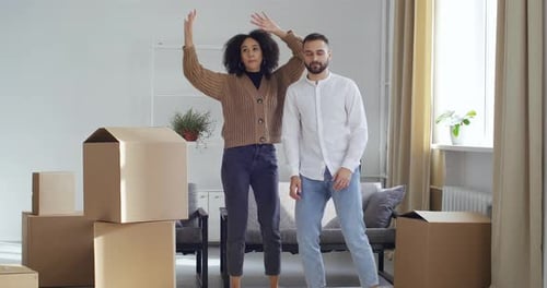 Couple Dancing in New Apartment Surrounded by Boxes