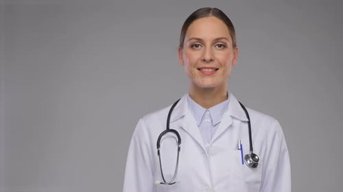 Smiling Woman Doctor in White Coat with Stethoscope