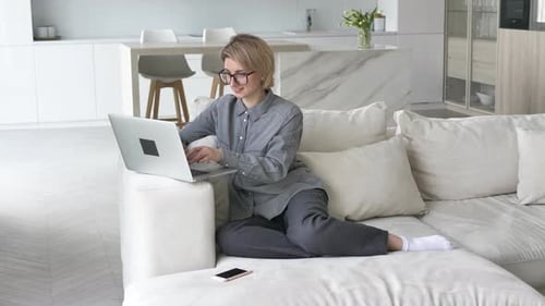 Woman on Laptop at Home, Remote Work