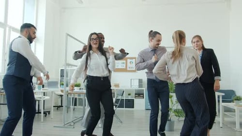 Slow Motion of Multiethnic Group of Young People Dancing Having Fun in Office