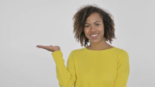 Smiling Young Woman Presenting Gesture on White Background