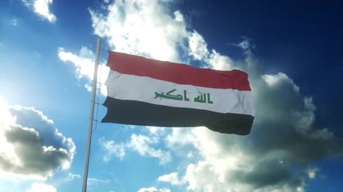 Waving Iraq National Flag Against Bright Blue Sky