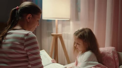Mother Reading Bedtime Story to Child at Home