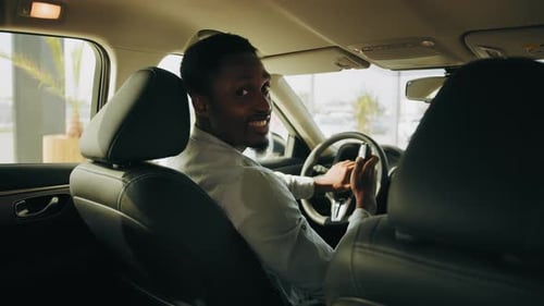 Young Adult Smiling in New Car Interior