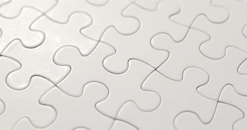 Completed White Jigsaw Puzzle Pieces Close Up