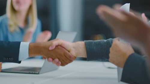 Successful Business Deal Handshake with Applauding Colleagues