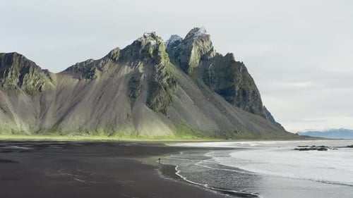 Drone Of Man On Black Beach Under Vestrahorn Mountain