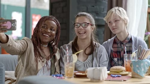 Three Young Women Taking a Selfie in Cafe