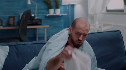 Man with a Cold Resting on Couch