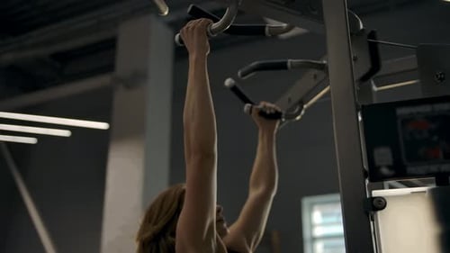 Woman Doing Pull Ups at Gym