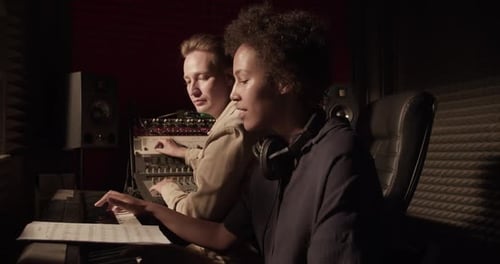 Musicians Collaborate in Recording Studio