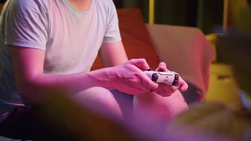 Man Playing Video Games at Home at Night