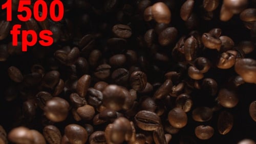 Roasted Coffee Beans Falling Against Dark Backdrop