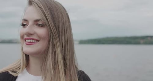 Smiling Woman with Blonde Hair Laughing Outdoors