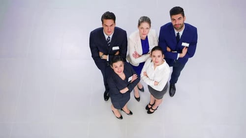 Businesspeople standing with arms crossed in office